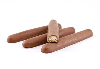 Stick biscuits fully covered with chocolate on white background