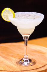 Alcoholic cocktail on wooden board