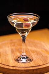 Alcoholic cocktail on wooden board