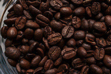 Closeup of roasted coffee beans. Macro of brown coffee beans with copy space.