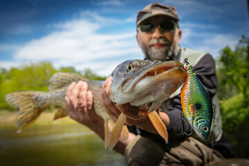 Fishing. Fisherman and trophy Pike.