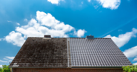 A half cleaned house roof shows the before and after effect of a roof cleaning. - obrazy, fototapety, plakaty