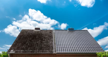 Foto op Canvas A half cleaned house roof shows the before and after effect of a roof cleaning. © Fokussiert