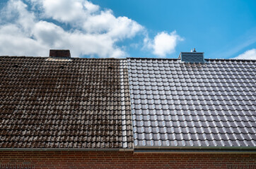 A half cleaned house roof shows the before and after effect of a roof cleaning. - obrazy, fototapety, plakaty