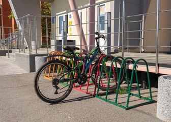 bicycle parking in front of the building, bicycle parked near the entrance to the school, colored...