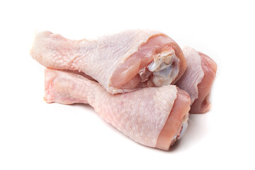 Raw chicken legs with skin on a white background.