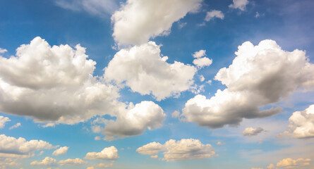 Blue sky with white plump fluffy clouds and sun. Cumulus clouds. Nature weather blue sky. Beautiful...