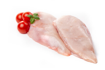 Chicken breast fillet decorated with tomatoes and basil on a white background.