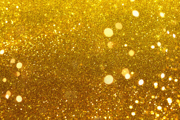 Shiny iridescent gold background with tints and lights. Golden Christmas tinsel background