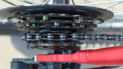 Close-up of a rear set of gear shifting sprockets on the rear wheel of a modern mountain bike with chain. Bicycle repair.