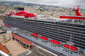Futuristic modern cruiseship or cruise ship liner Scarlet Lady in red and grey in port of Genoa,...