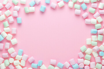 Frame made of marshmallows. Marshmallows on pink background