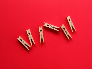 wooden clothespins on a red background
