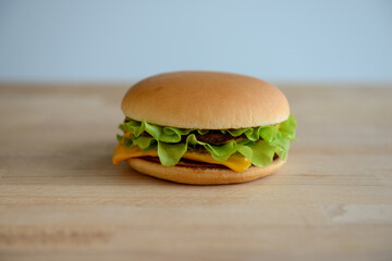 Hamburger or cheeseburger closeup on a wooden background