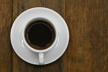 black coffee in white seramic glasses on an old wooden floor