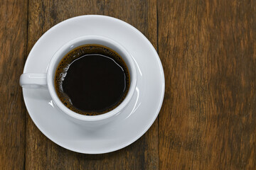 top view of black coffee in white seramic glasses on  old background