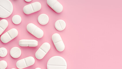 Medicine pills on pink background. Copy space. Top view