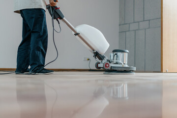 worker cleaning floor with machine