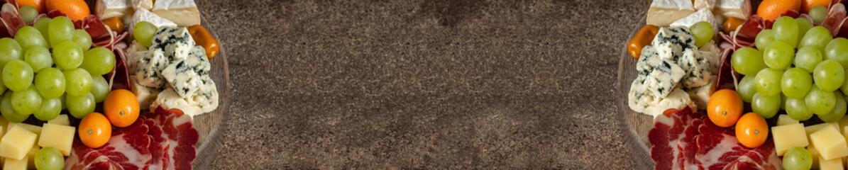 Platter board with different sorts of cheese, grape, cumquat and ginger jam on brown background, menu banner template