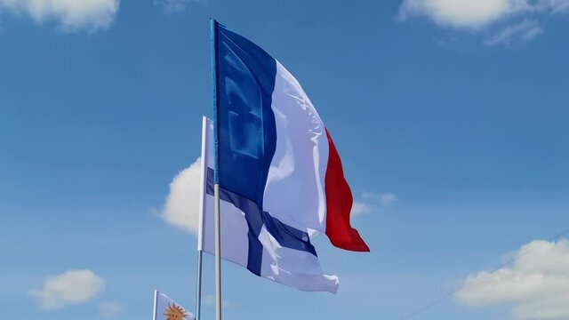 Finland. French. National country flag on blue sky background. Flying fabric symbol. Tourism or travel summer day. international patriotic emblem. Nobody. Horizontal video
