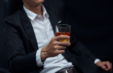 Man wearing a suit whiskey glass of liquor 
