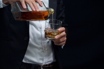 Man wearing a suit whiskey glass of liquor 