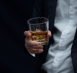 Man wearing a suit whiskey glass of liquor 