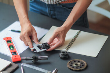 The factory mechanical engineering team is designing and developing gear sets to keep the machines running perfectly because gear sets are essential in the working system of large machines.