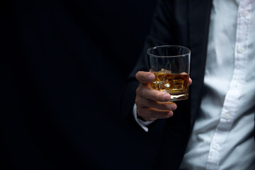Man wearing a suit whiskey glass of liquor 