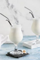 Foto op Plexiglas Glasses with tasty vanilla milkshake on color background © Pixel-Shot