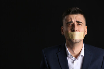 Male hostage on dark background