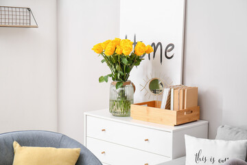 Vase with yellow roses in interior of living room