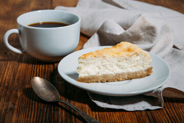 cheesecake and coffee on wooden background 