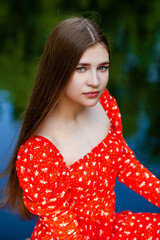 Portrait of a young beautiful teenager girl in red dress