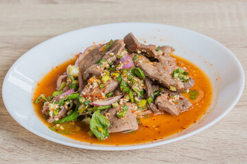 Pork liver spicy salad in white dish, delicious thai food