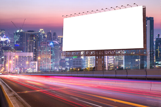 blank billboard on light trails street in the twilight or night city - can advertisement for display or montage product or business
