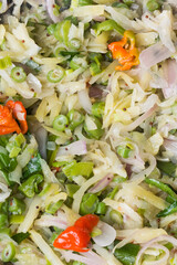 tempered vegetable dish, potatoes, beans and onions with mustard seeds, chilies and curry leaves, vegetarian dish closeup view