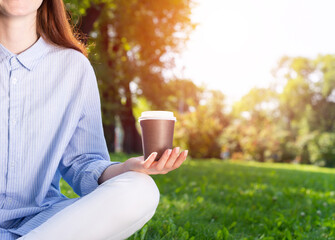 Young redhead woman meditating in lotus pose