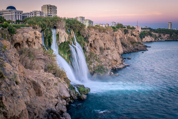 Obraz premium Waterfall Duden falling into the Mediterranean sea in Antalya, Turkey. Sunset in Antalya