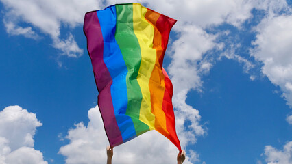 Flag Rainbow LGBT Communite in a month of dignity or a parade on a background of blue sky with...