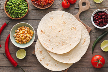 Ingredients for preparing tacos on wooden background