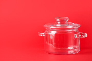 Stylish cooking pot on color background