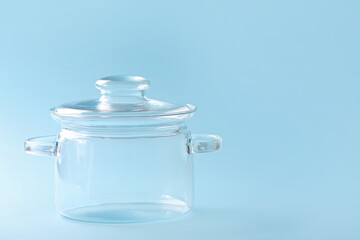 Stylish cooking pot on color background