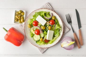 Composition with fresh salad on light wooden background