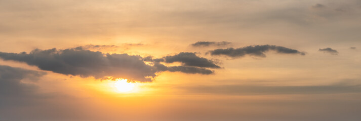 Fototapeta na wymiar Panorama orange sunset sky with sun and cloud. Using as nature cover page.