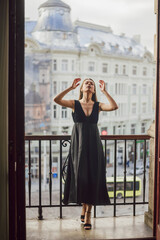 Young woman wearing black dress and preparing for a date