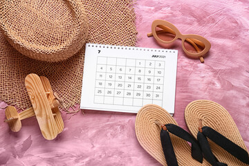 Fototapeta na wymiar Calendar and beach accessories on color background