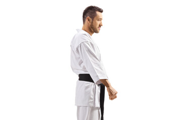Fototapeta premium Young man in karate kimono with black belt