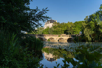 Fototapeta na wymiar Castle Raoul and bridge with Reflection in Water, Chateauroux city, France