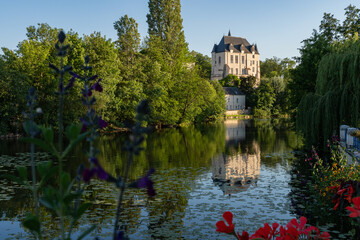 Castle Raoul with Red Flower and Reflection in Water in Chateauroux city, France - obrazy, fototapety, plakaty
